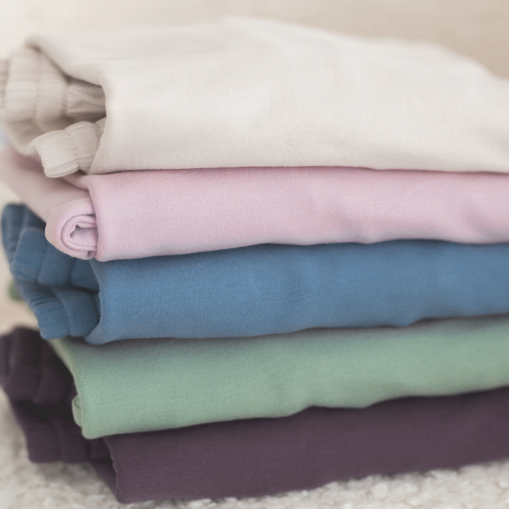A stack of Milana Label jogger sets in 5 different colours.