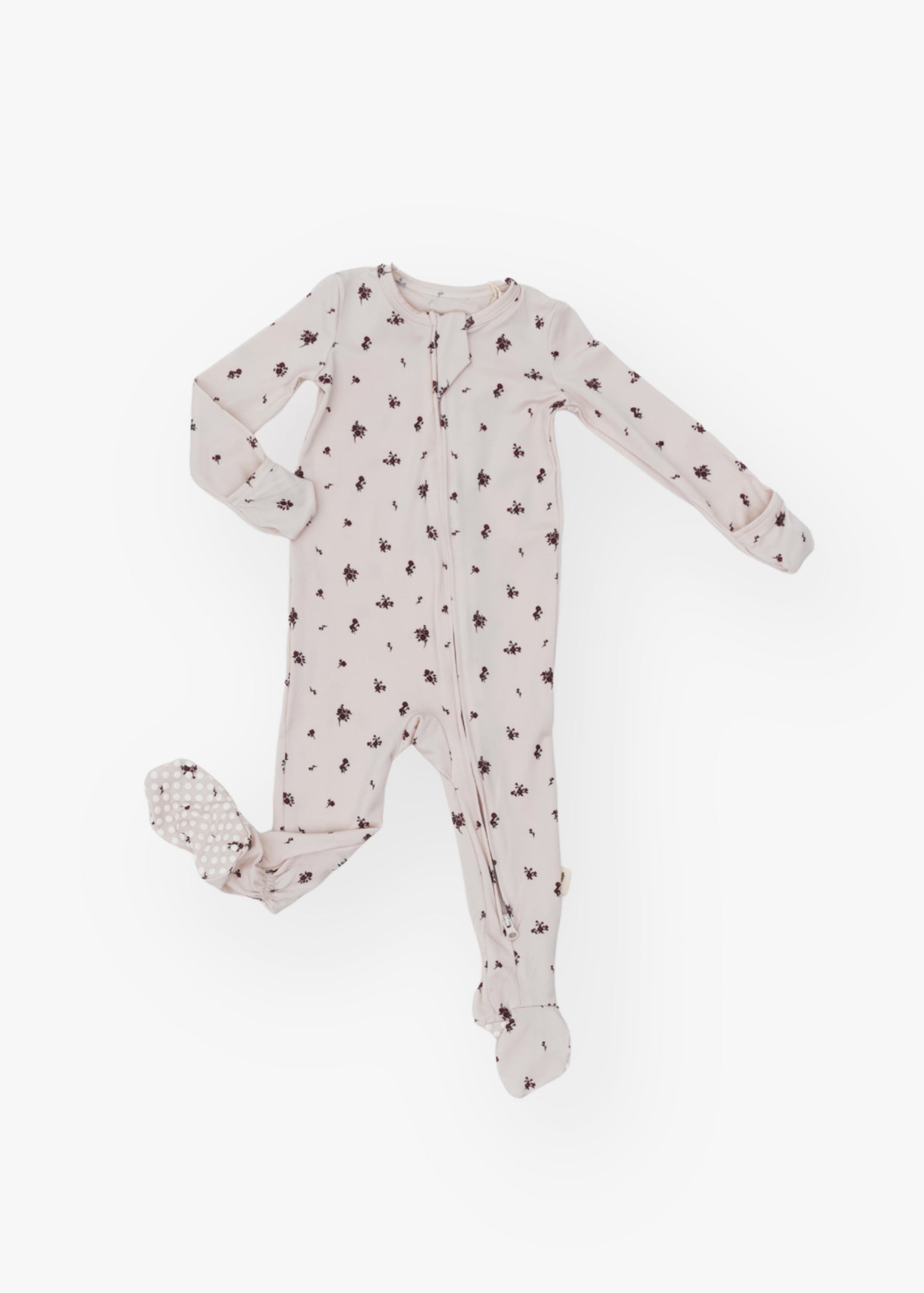 Milana Label kids zip footie sleeper in Birch Floral, a warm neutral fabric with a scattered dark floral print, with grip dots on the feet.