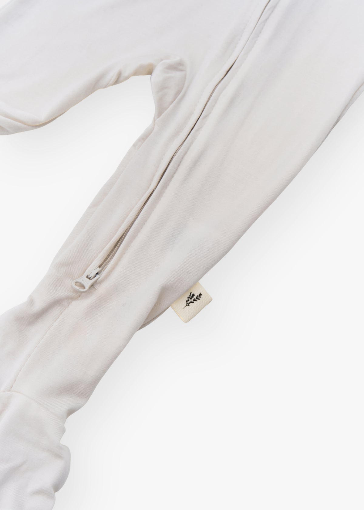 Milana Label kids zip footie sleeper in Birch, a warm neutral tone, with grip dots on the feet.
