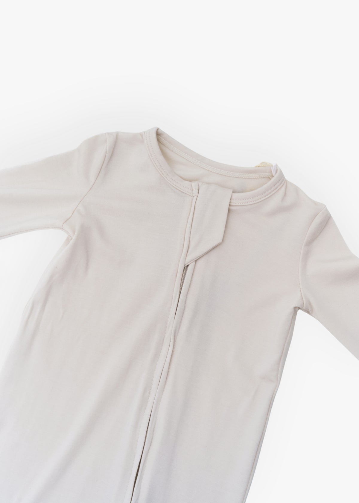 Milana Label kids zip footie sleeper in Birch, a warm neutral tone, with grip dots on the feet.
