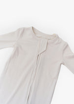 Milana Label kids zip footie sleeper in Birch, a warm neutral tone, with grip dots on the feet.