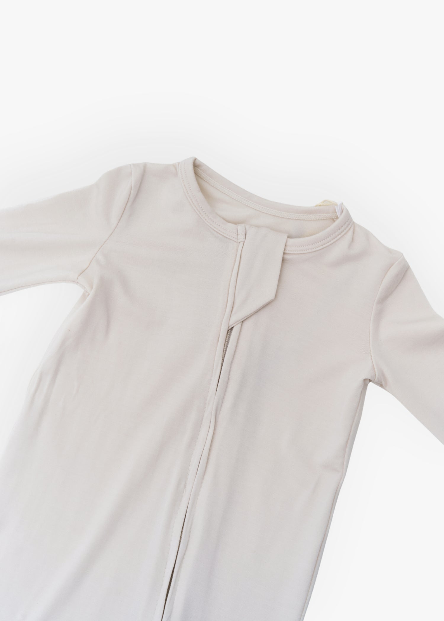 Milana Label kids zip footie sleeper in Birch, a warm neutral tone, with grip dots on the feet.