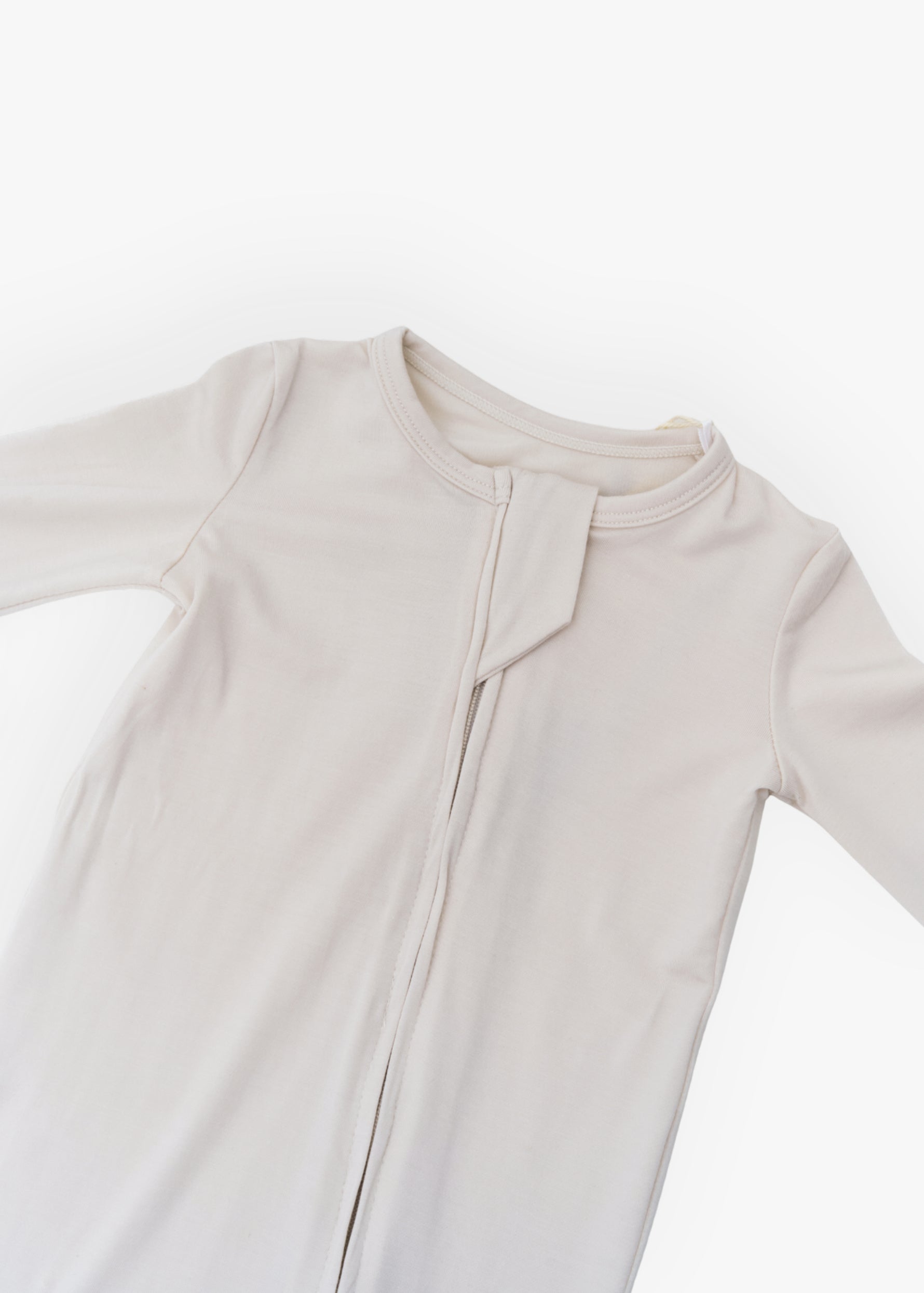 Milana Label kids zip footie sleeper in Birch, a warm neutral tone, with grip dots on the feet.