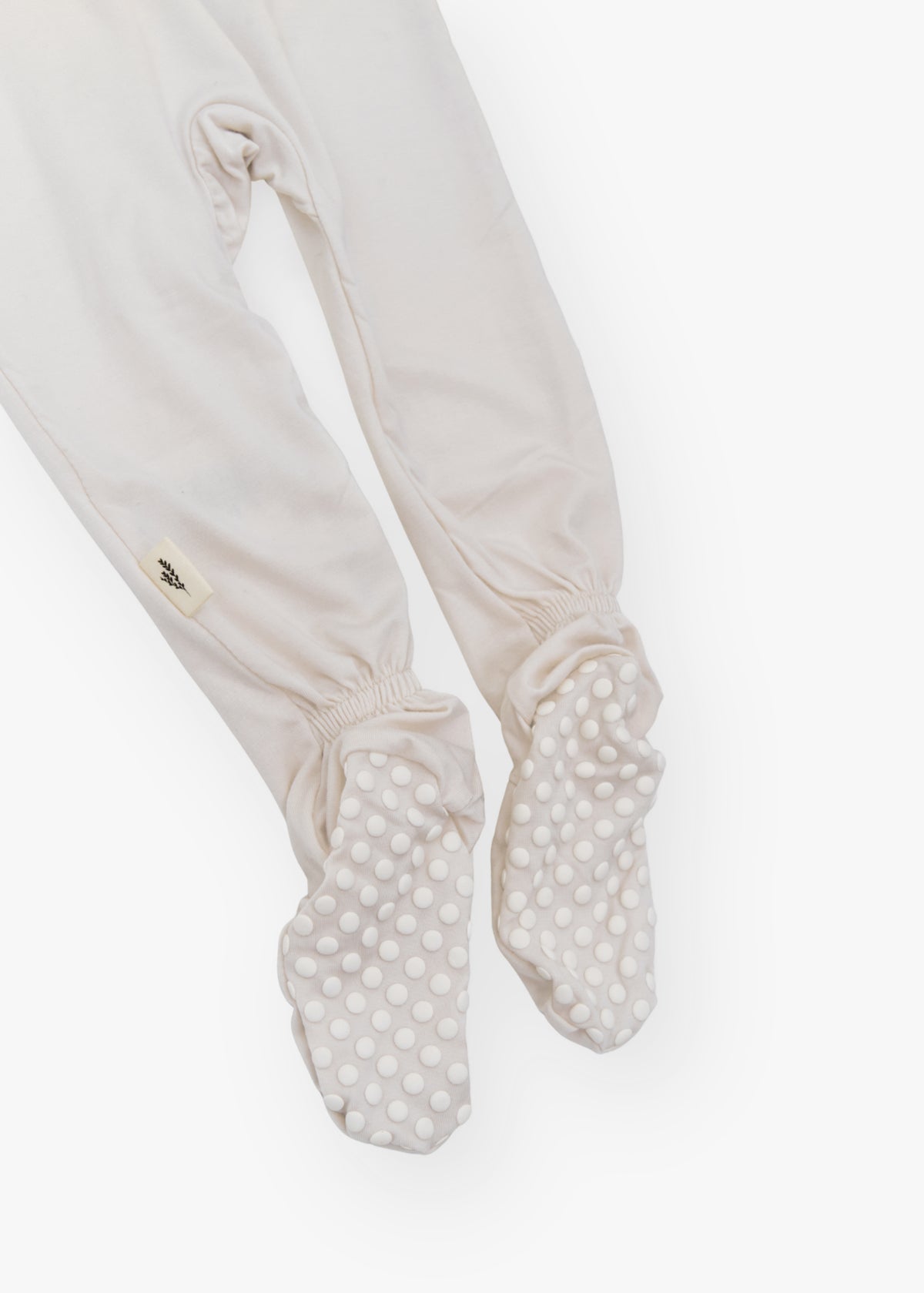 Milana Label kids zip footie sleeper in Birch, a warm neutral tone, with grip dots on the feet.