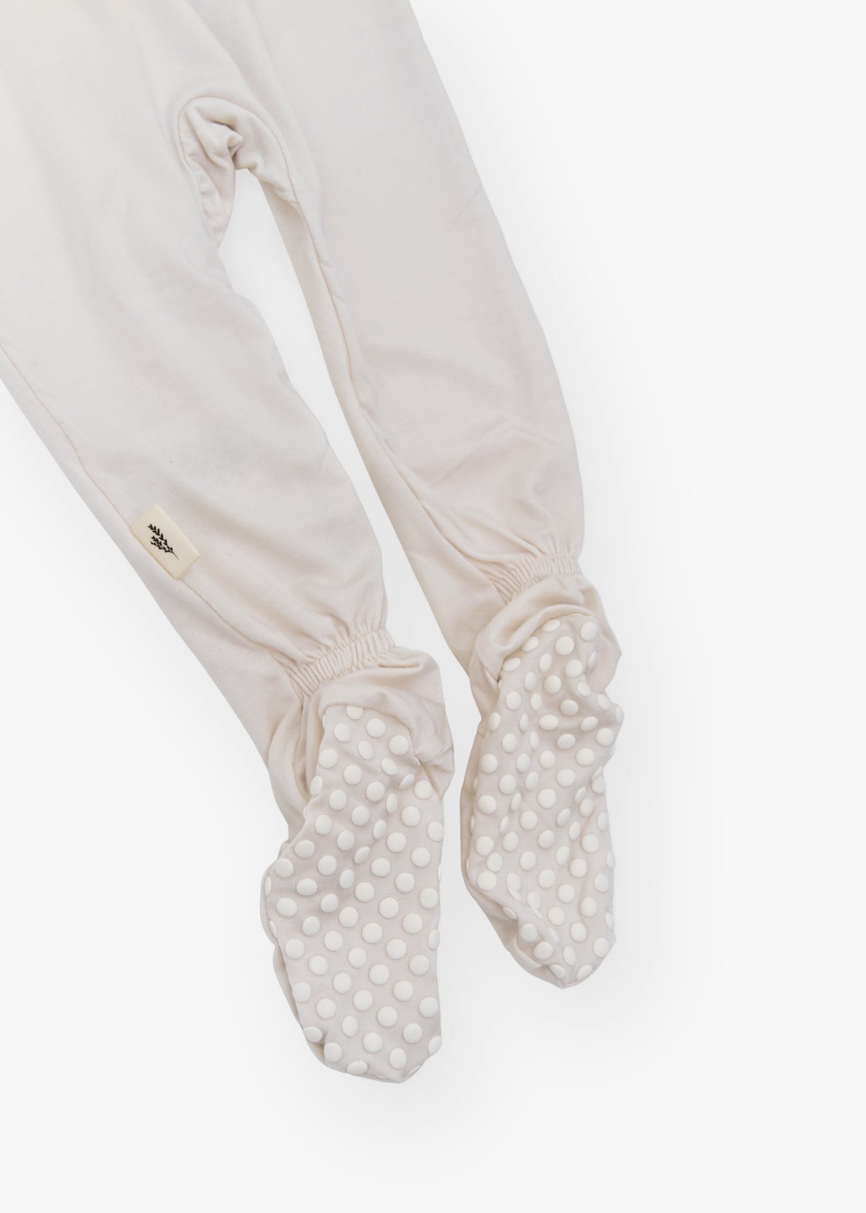 Milana Label kids zip footie sleeper in Birch, a warm neutral tone, with grip dots on the feet.
