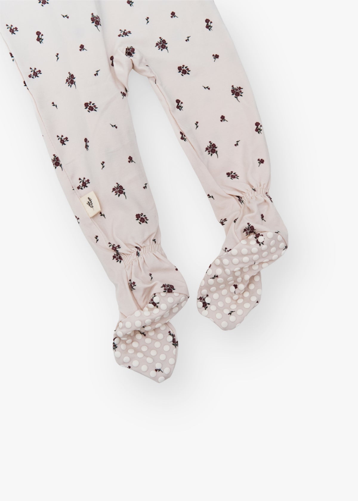 Milana Label kids zip footie sleeper in Birch Floral, a warm neutral fabric with a scattered dark floral print, with grip dots on the feet.