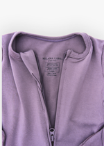 Milana Label kids zip footie sleeper in Wild Mulberry, a muted dusty purple tone, with grip dots on the feet.