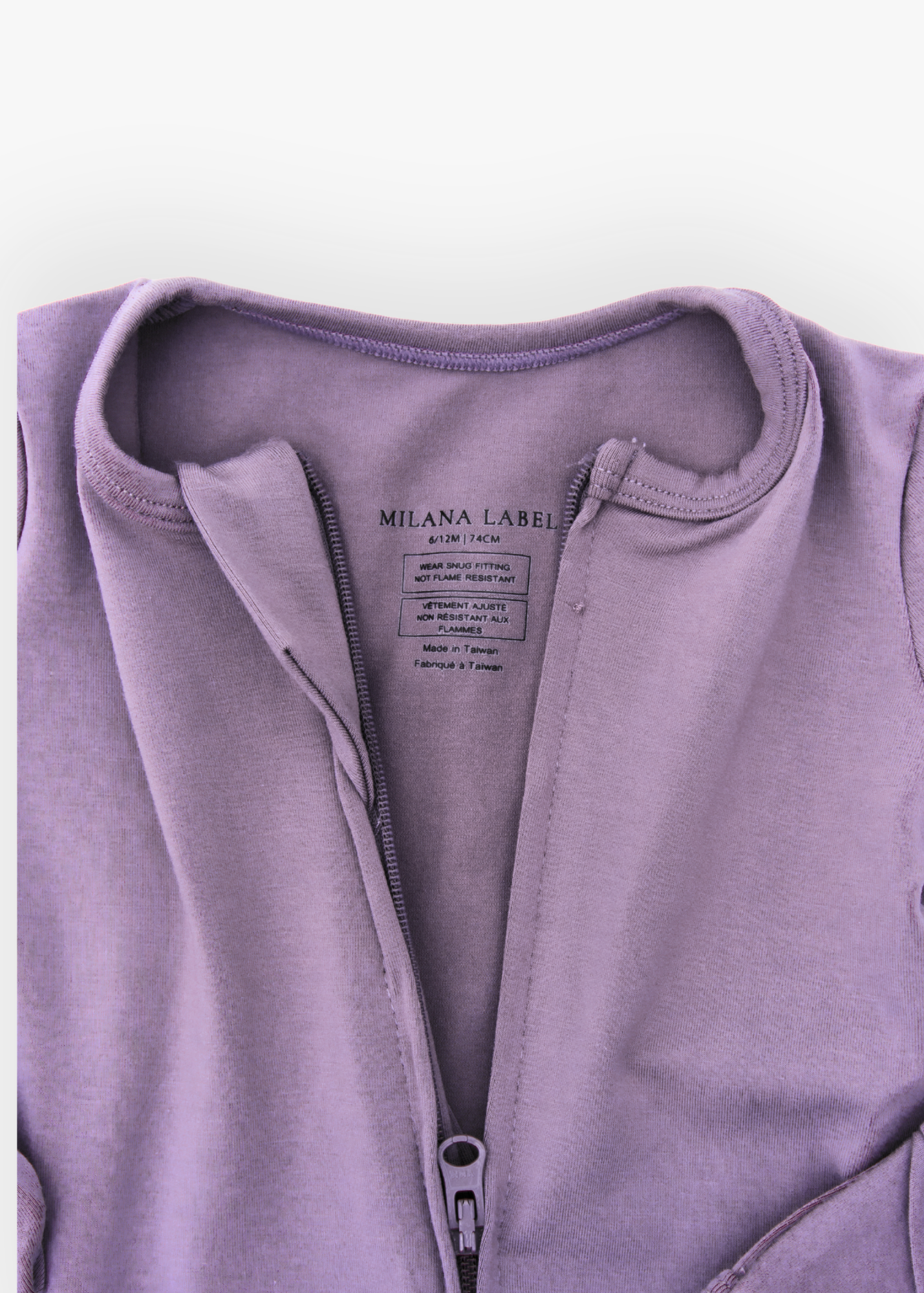 Milana Label kids zip footie sleeper in Wild Mulberry, a muted dusty purple tone, with grip dots on the feet.