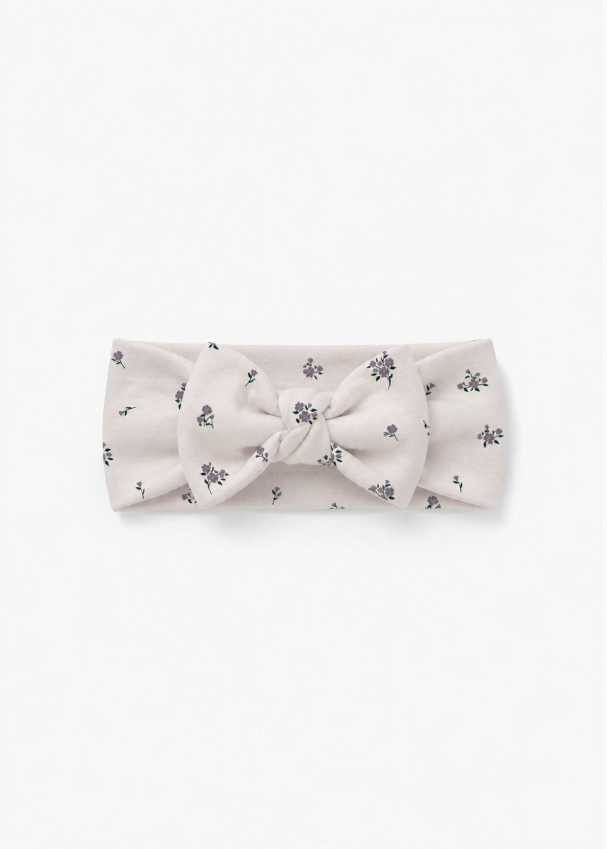 Milana Label baby bow headband in Birch Floral, warm neutral fabric with a scattered purple floral print, photographed flat against a white background.