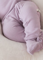 Close-up detail of a baby wearing the Lavender Blush organic cotton footie sleeper, highlighting the soft ribbed fabric and enclosed footies.