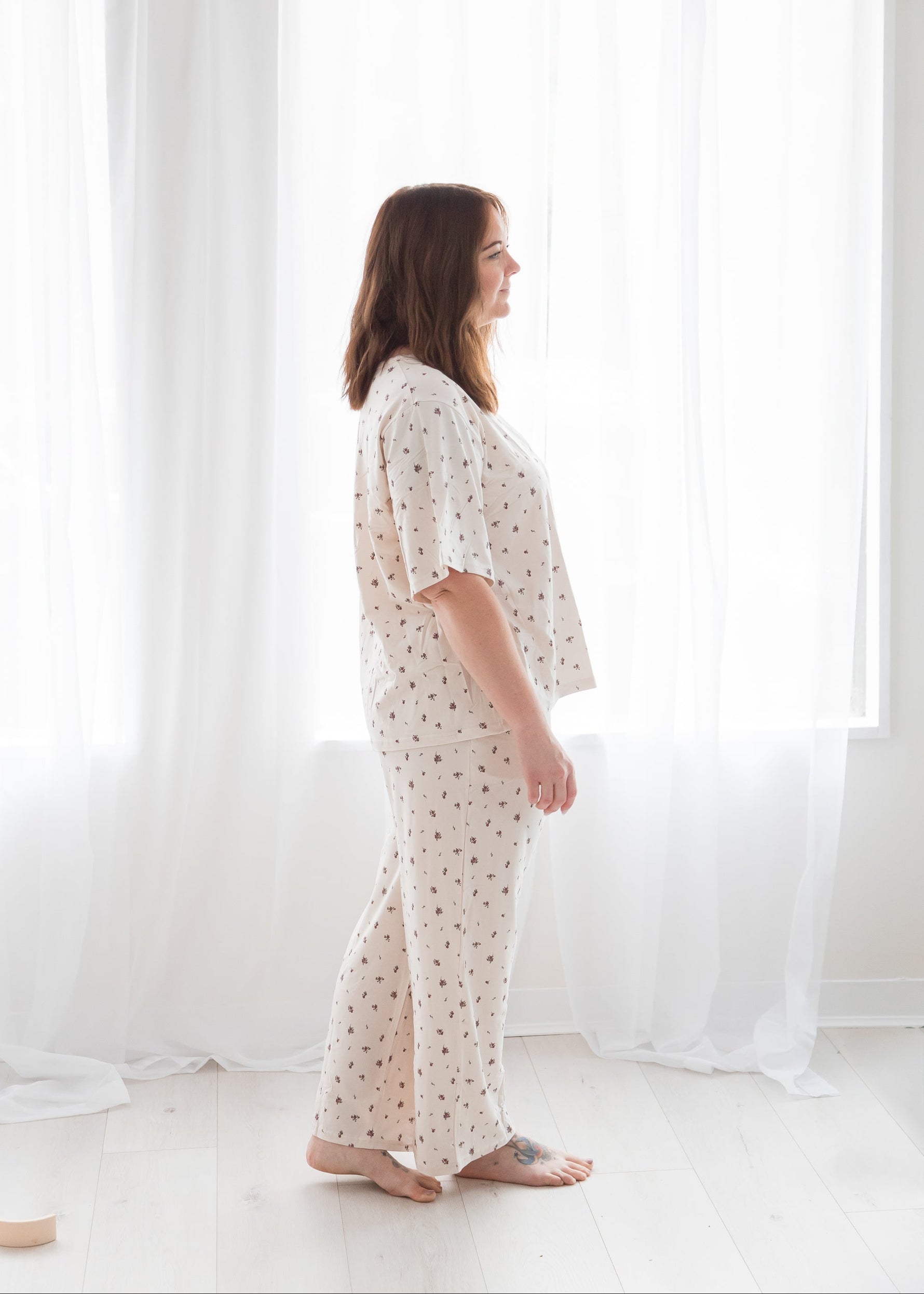 Side profile view of a woman wearing a comfortable Tencel lounge and sleepwear set in Birch Floral by Milana Label.