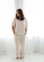 A woman smiling while wearing a Milana lounge set crafted from soft TENCEL fabric.