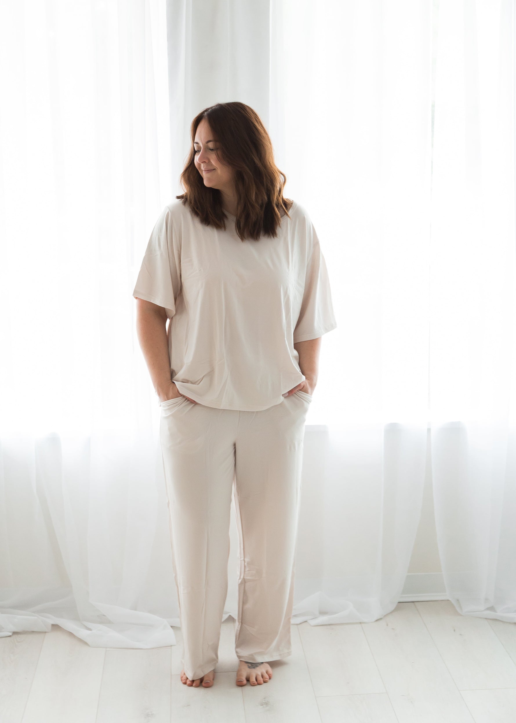 A woman smiling while wearing a Milana lounge set crafted from soft TENCEL fabric.