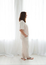 A woman wearing the Milana Label lounge set in the colour Birch, left side angle.