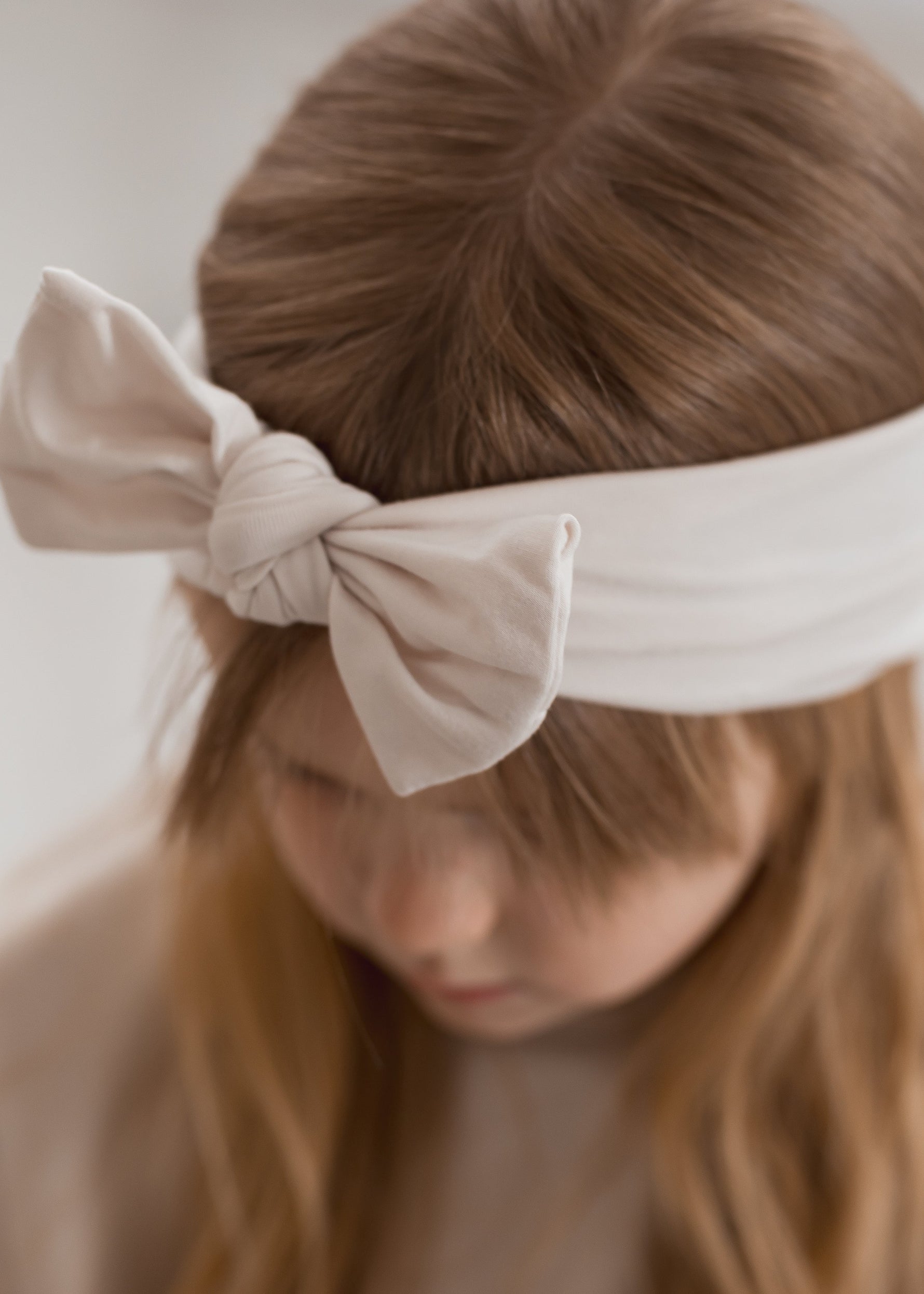 A close up of the Milana Label knot headband in the colour Birch. A soft neutral that matched the full Milana Soft line.