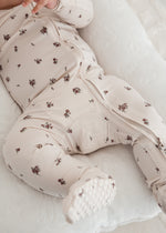 A close up of a Milana Label sleeper in the colour Birch Floral highlighting the premium fabric. 