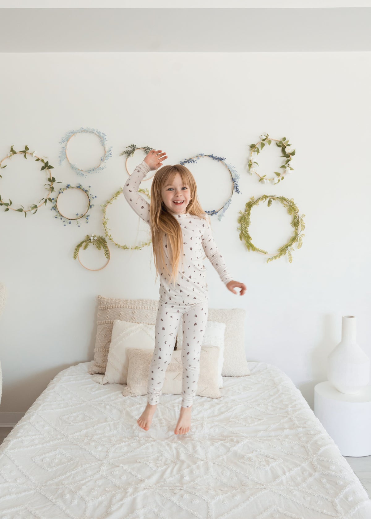 A kid jumping on a bed in her pajamas by Milana. Crafted from TENCEL and apart of the Milana Soft collection.