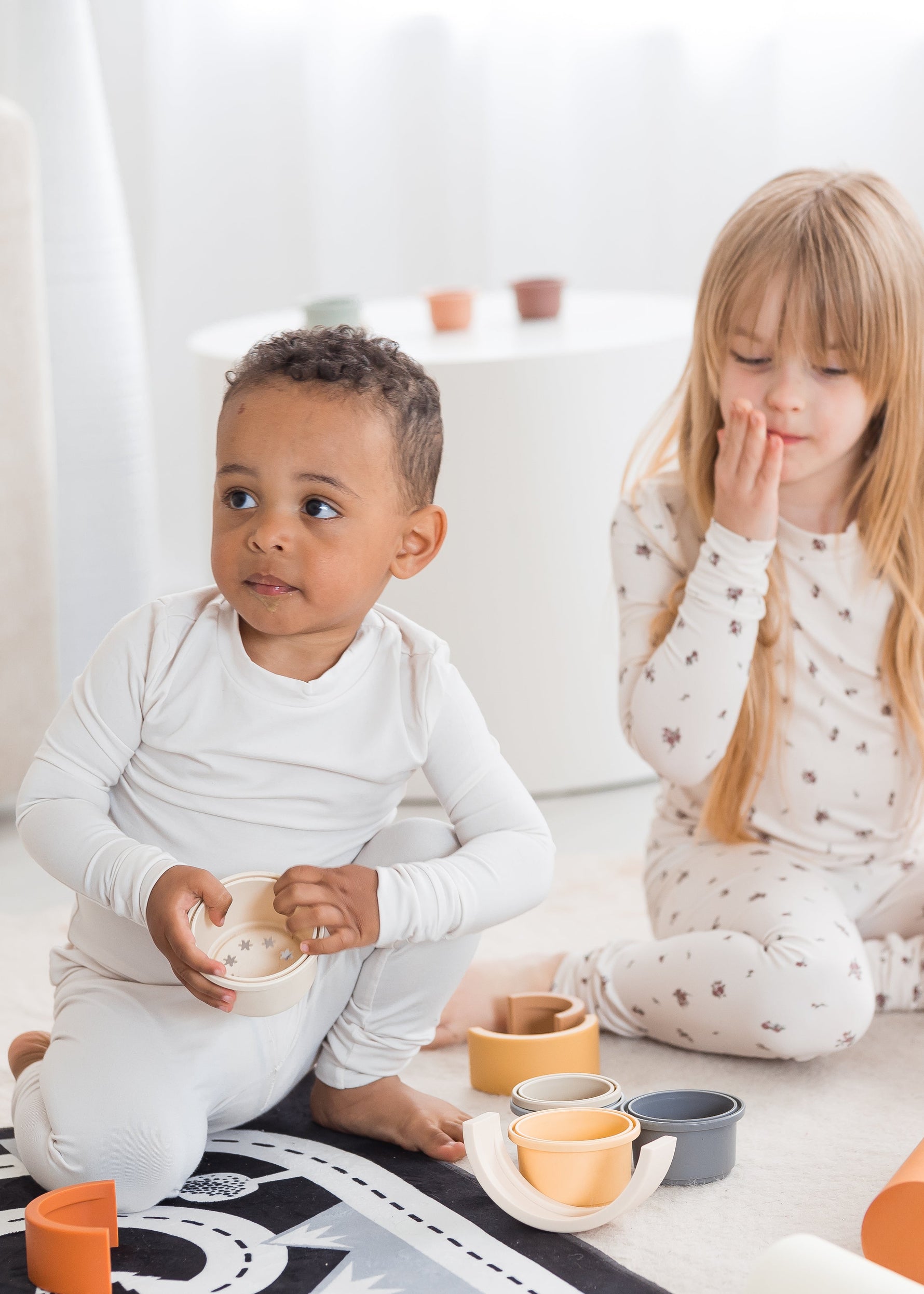 Two kids playing on the floor in their Milana Soft PJ sets crafted from TENCEL.