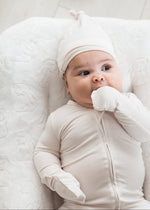Infant wearing a Milana Label sleeper in the colour Birch, showing the fold-over cuff detail. 