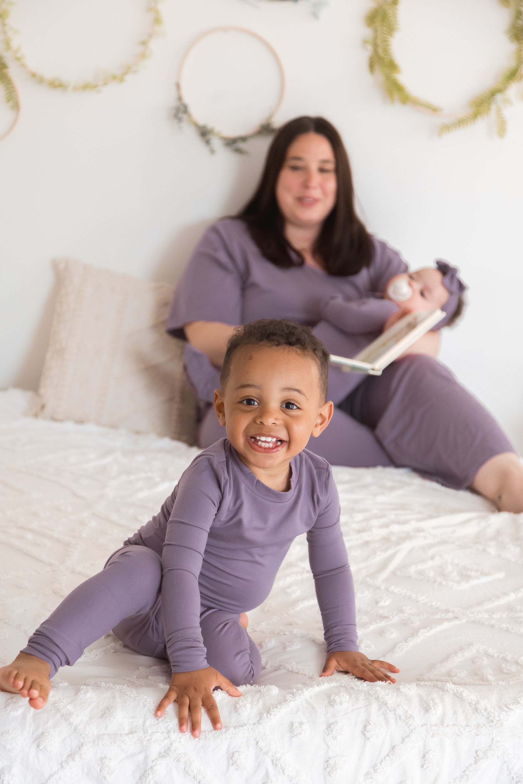 A mom and her kids wearing their matching Milana PJ's in the colour Wild Mulberry.