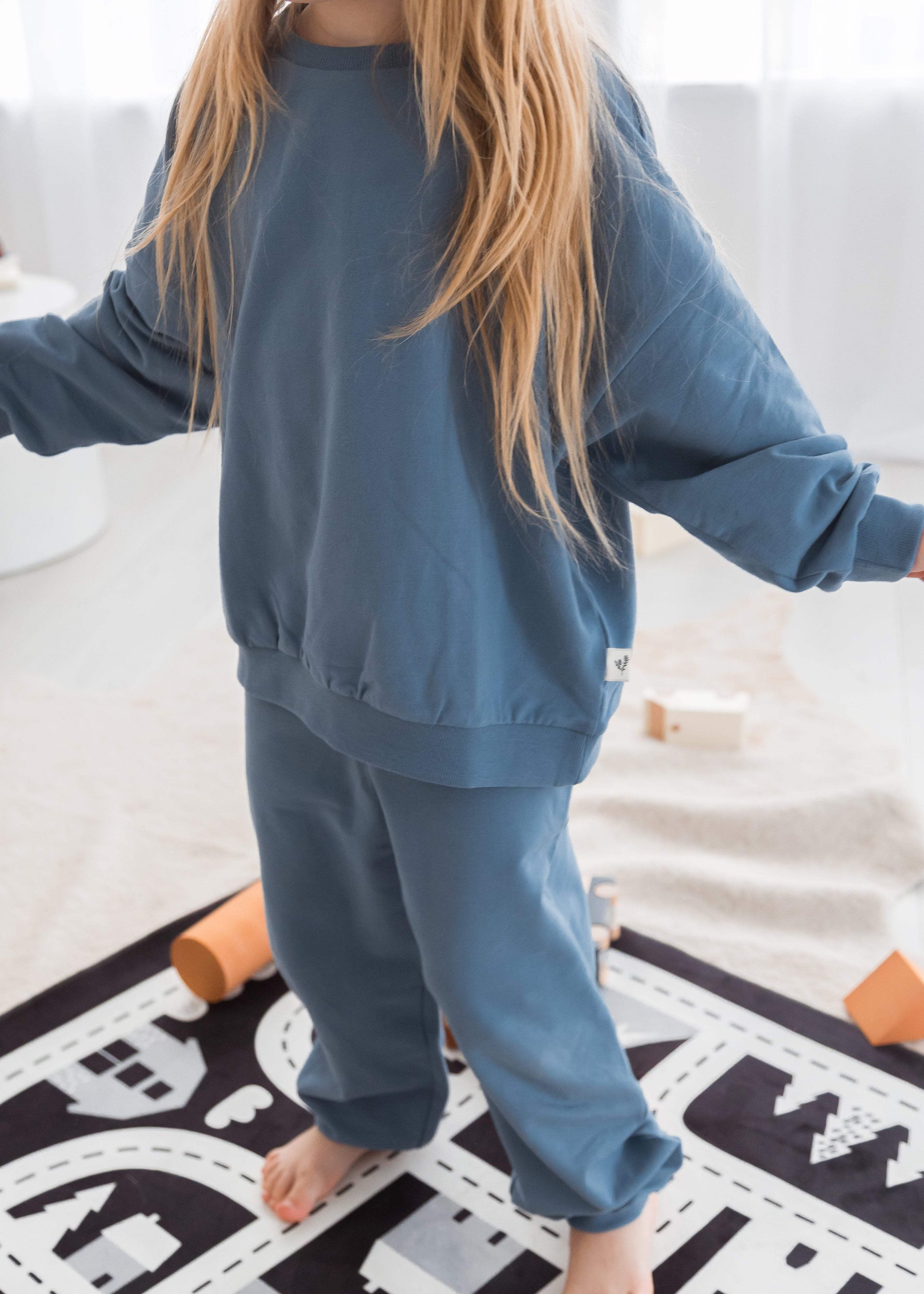 A close-up of a GOTS certified organic cotton jogger set by Milana Label in the colour Nordic Blue.