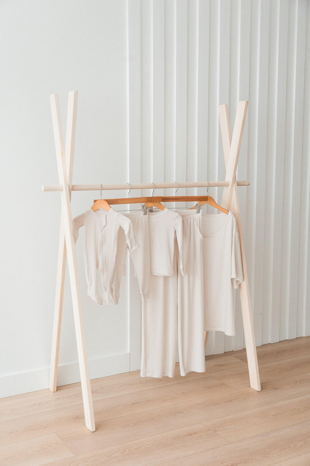 Milana Label's neutral collection hanging on a clothing rack.