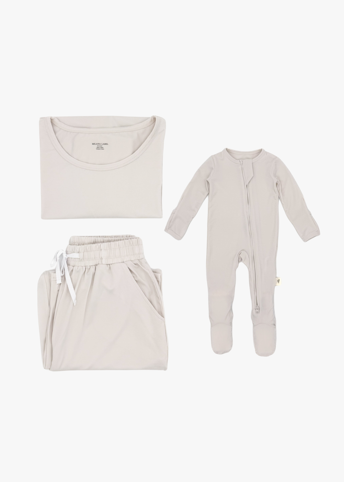 Milana Label mommy and me sleeper bundle in Birch, adult two-piece lounge set and baby zip footie sleeper laid flat together.