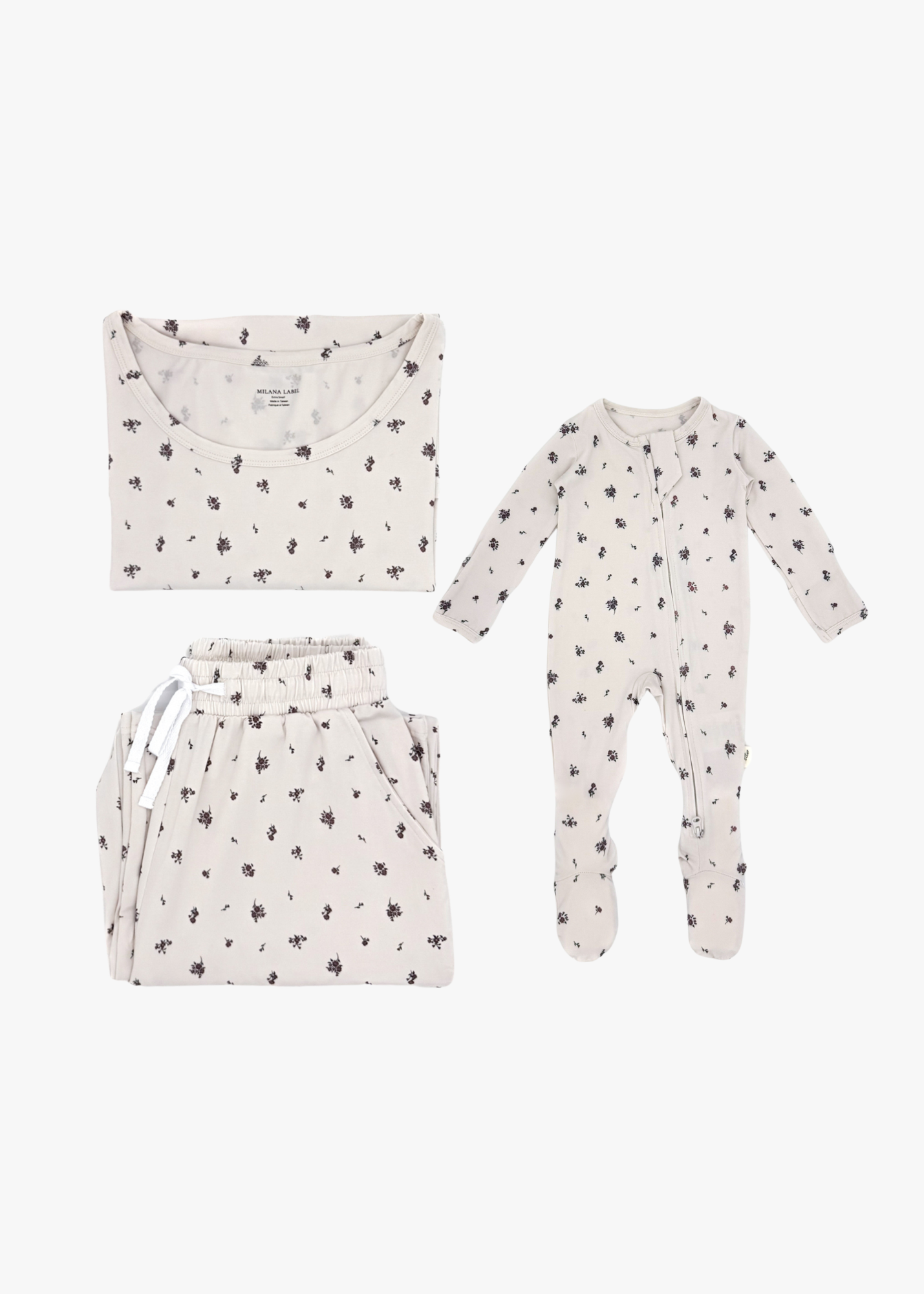 Milana Label mommy and me sleeper bundle in Birch, adult two-piece lounge set and baby zip footie sleeper laid flat together.