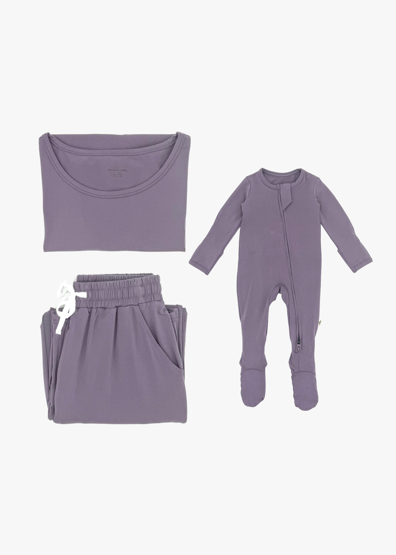 Milana Label mommy and me sleeper bundle in Wild Mulberry, adult two-piece lounge set and baby zip footie sleeper laid flat together.