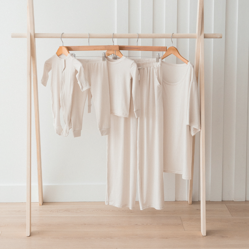 Milana Label's neutral collection hanging on a clothing rack.