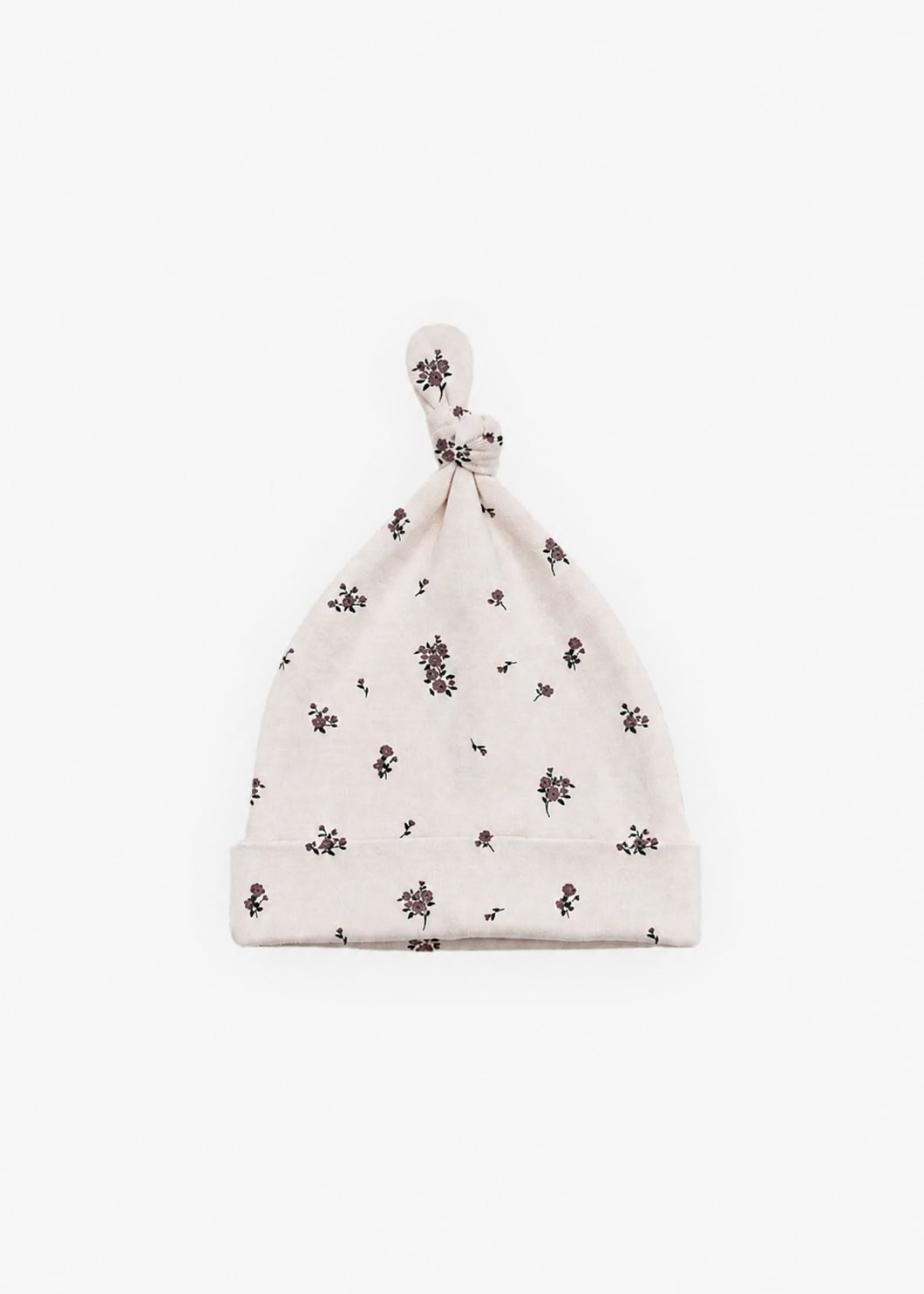 Milana Label knotted baby hat in Birch Floral, a warm cream fabric with a scattered dark floral print, photographed flat against a white background.