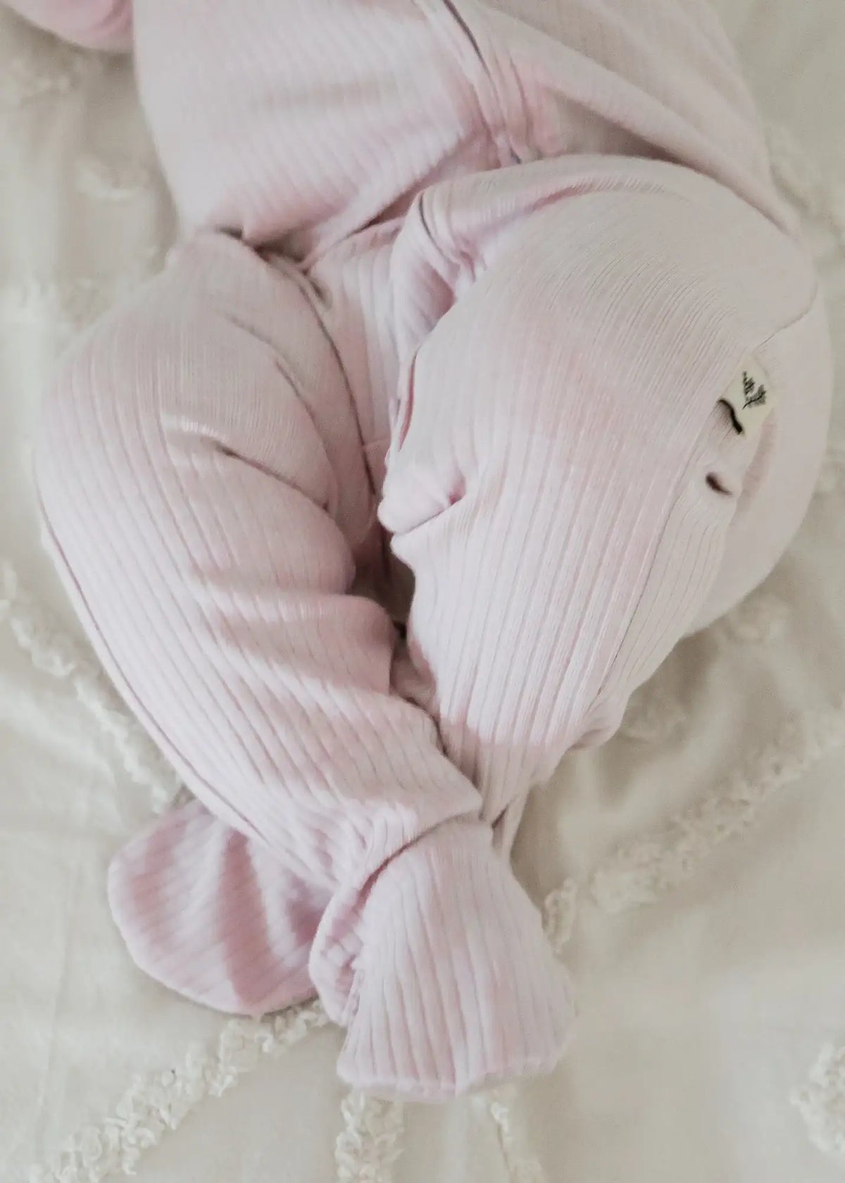 A close up of the feet on the Milana Label ribbed zippered sleeper.