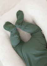 Close-up of the foot grip feature on a Pine green organic baby sleeper.