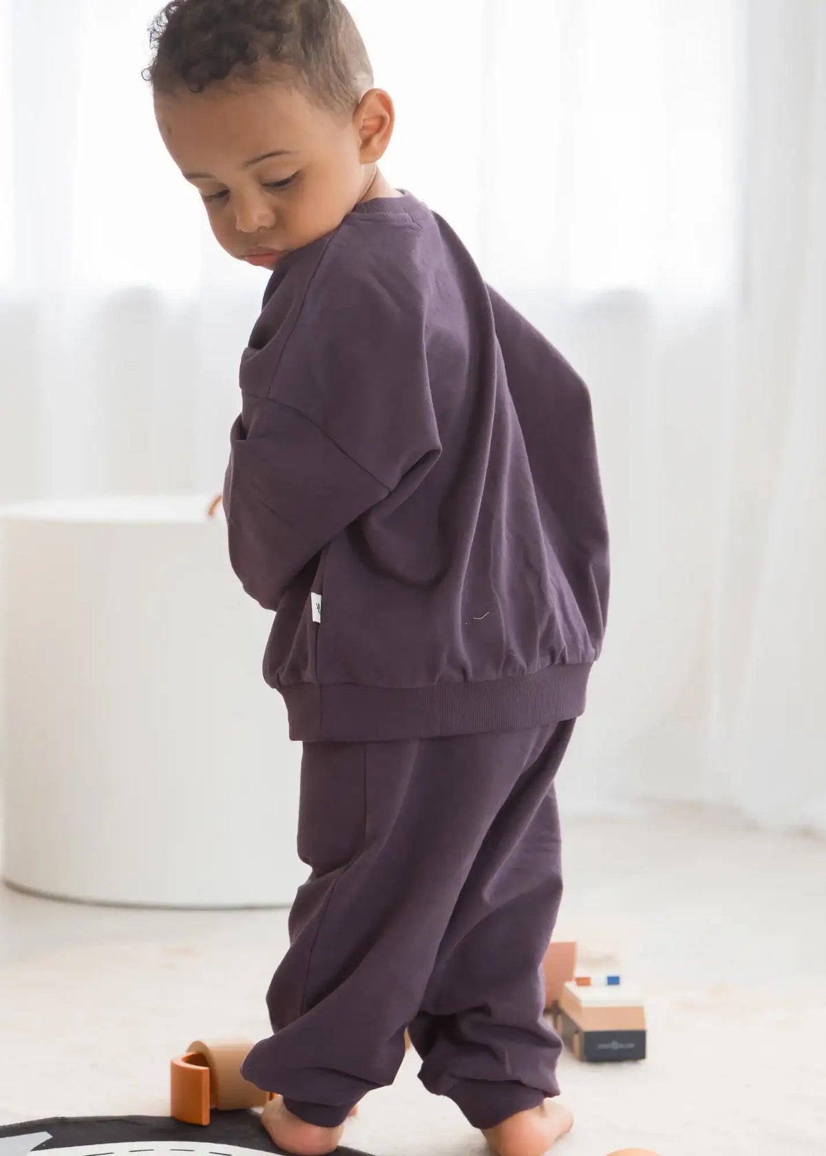 A close-up of the organic cotton fabric used in the Milana Label jogger set in Elderberry purple.