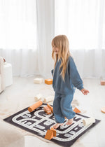 A girl playing while wearing a matching two-piece set in the colour Nordic Blue by Milana.