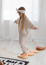 The side view of a Milana Label jogger set in the colour Oat.