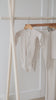 Milana Label neutral pj collection hanging on a clothing rack.